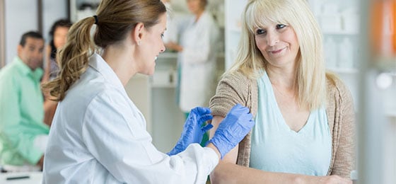 pharmacist administering vaccine