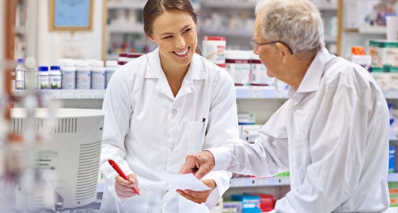 pharmacist assisting elderly patient